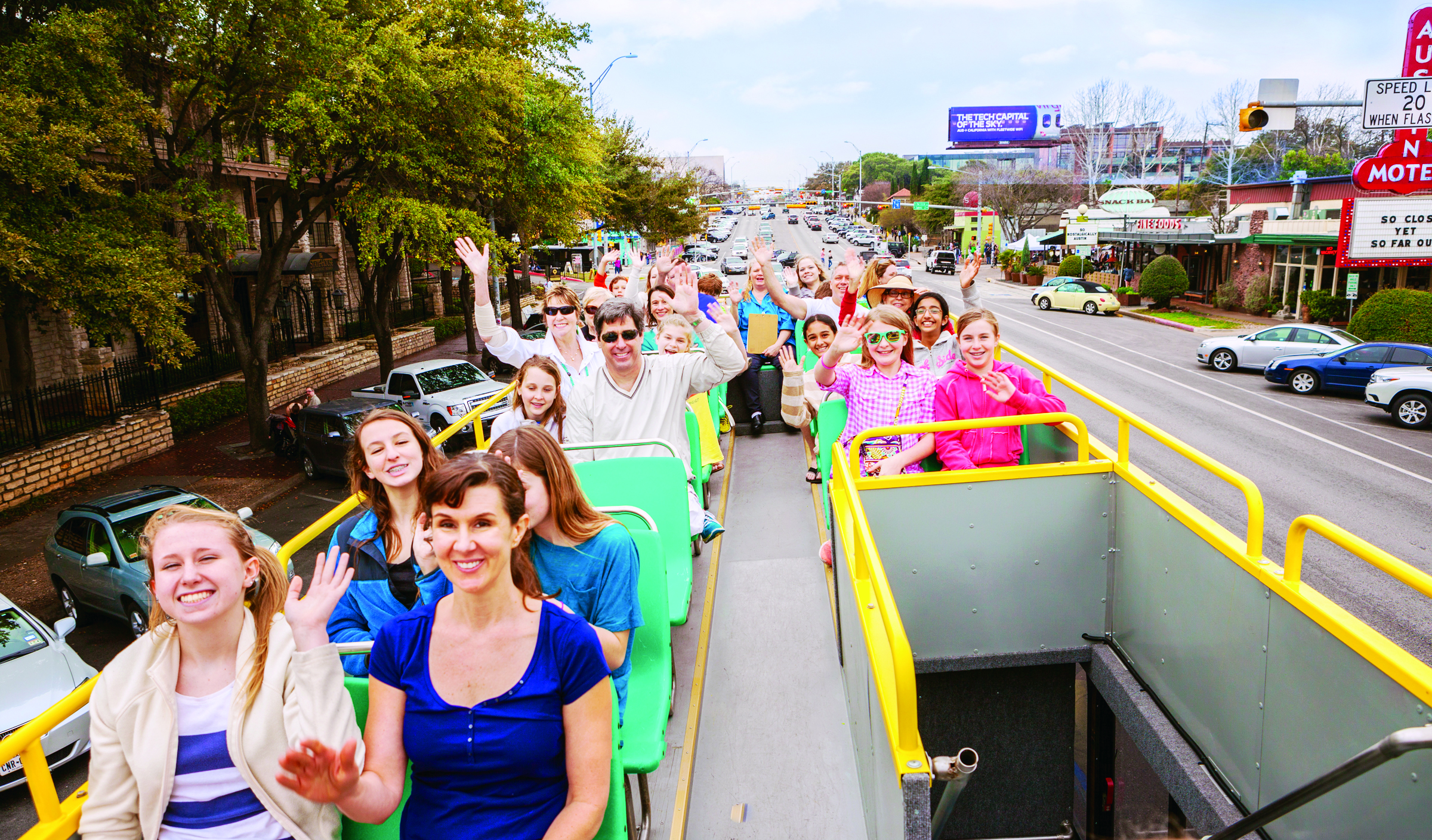 Friends enjoying the upper deck of the Double Decker Austin tour bus on South Congress Avenue